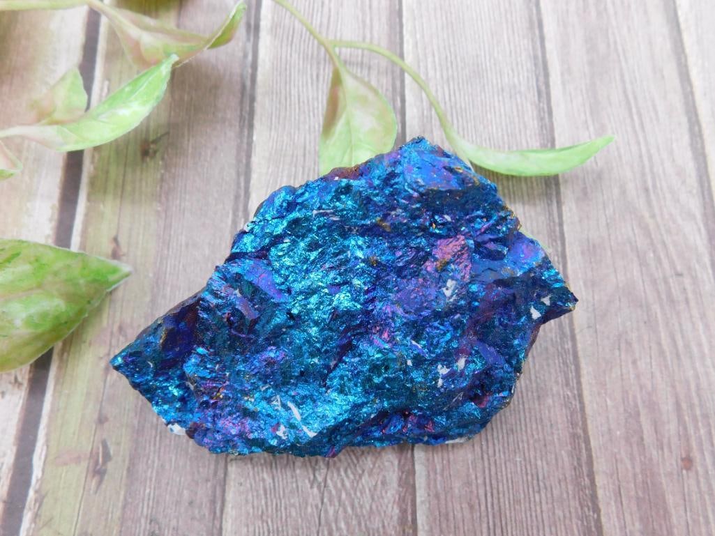 Colorful Metallic Chalcopyrite Rock Specimen: A colorful chalcopyrite mineral rock specimen displaying vibrant blue, purple, and metallic hues. This unique piece measures approximately 3 to 4 inches in length, as depicted next to a ruler. Ideal f