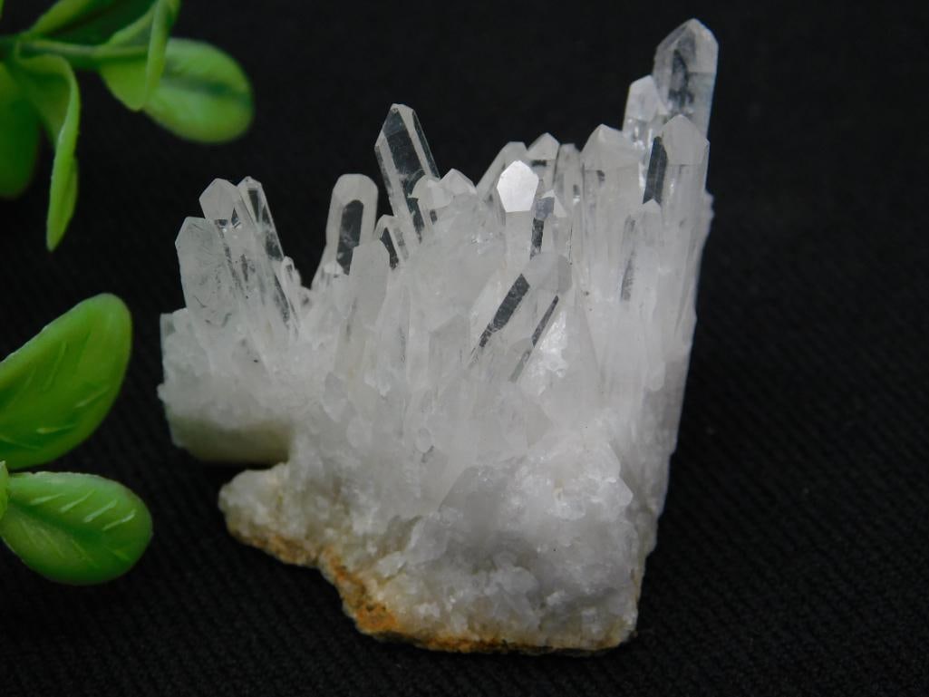Quartz Crystal Cluster Specimen: A captivating quartz crystal cluster specimen featuring multiple clear to white crystal points in a natural formation. The cluster is attached to an earthy base and weighs 27 grams. Ideal for collecto