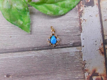 Gold-Tone Pendant with Blue Center Stone and Clear Accents