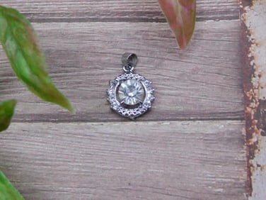 Round Pendant With Clear Gemstone and Surrounding Accents