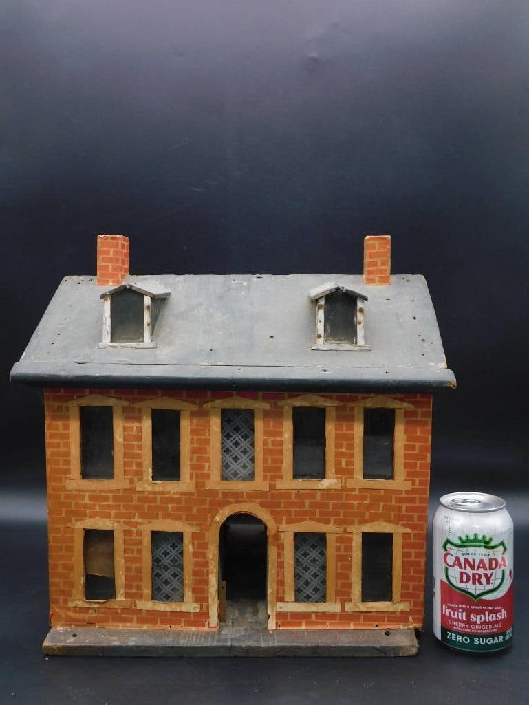 Vintage Wooden Dollhouse Brick Design ANTIQUE: - Two-story vintage wooden dollhouse featuring a brick facade design. | - Includes six visible window openings per side with decorative lattice-style panels. | - Front lower level includes an arched d