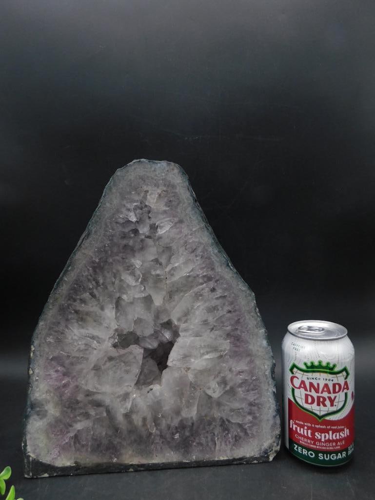 CATHEDRAL AMETHYST ROCK STONE LAPIDARY SPECIMEN: Natural amethyst crystal geode slice featuring light purple and gray hues. Cut and polished edges highlight the raw crystal formation. Includes a solid black backing for display stability. Approximate