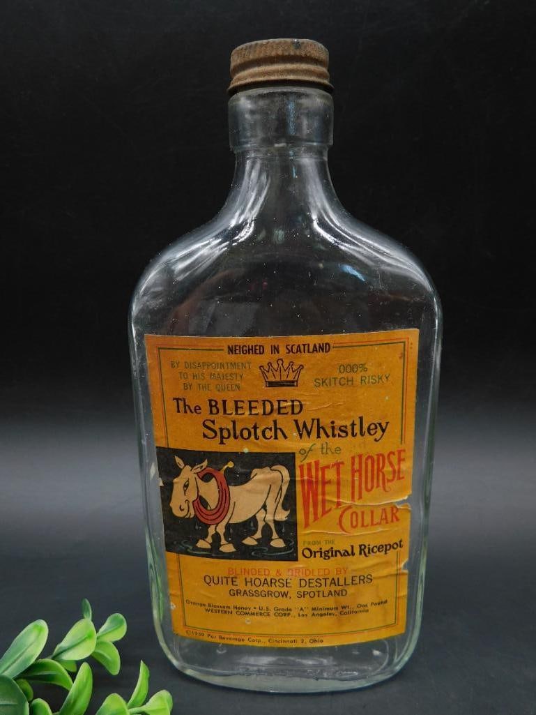 Glass Bottle of Blended Scotch Whiskey Wild Horse: Glass bottle with cork stopper and original paper label. The label reads "The BLEED Blended Scotch Whiskey of the Wild Horse Collar" and includes additional text and branding. Distillers are noted as 