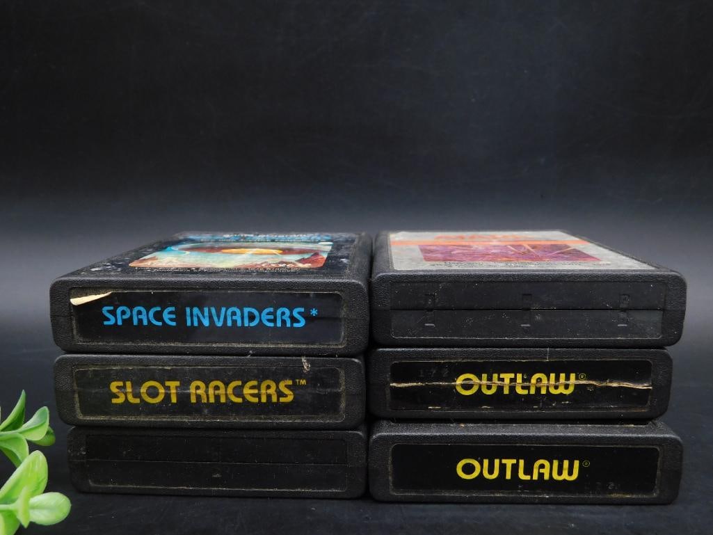 Collection of 5 Atari 2600 Game Cartridges: This lot includes a collection of 5 game cartridges for the Atari 2600 gaming console. Titles include: 2 copies of 'Outlaw,' 'Space Invaders,' 'Slot Racers,' and an additional game with a partially wo