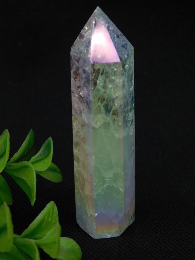 Iridescent Crystal Point Tower Weighing 30 Grams: A polished iridescent crystal point wand exhibiting translucent qualities and subtle reflective hues. Features a tapered, pointed design with a flat base. Weighs approximately 30 grams as indicated. I