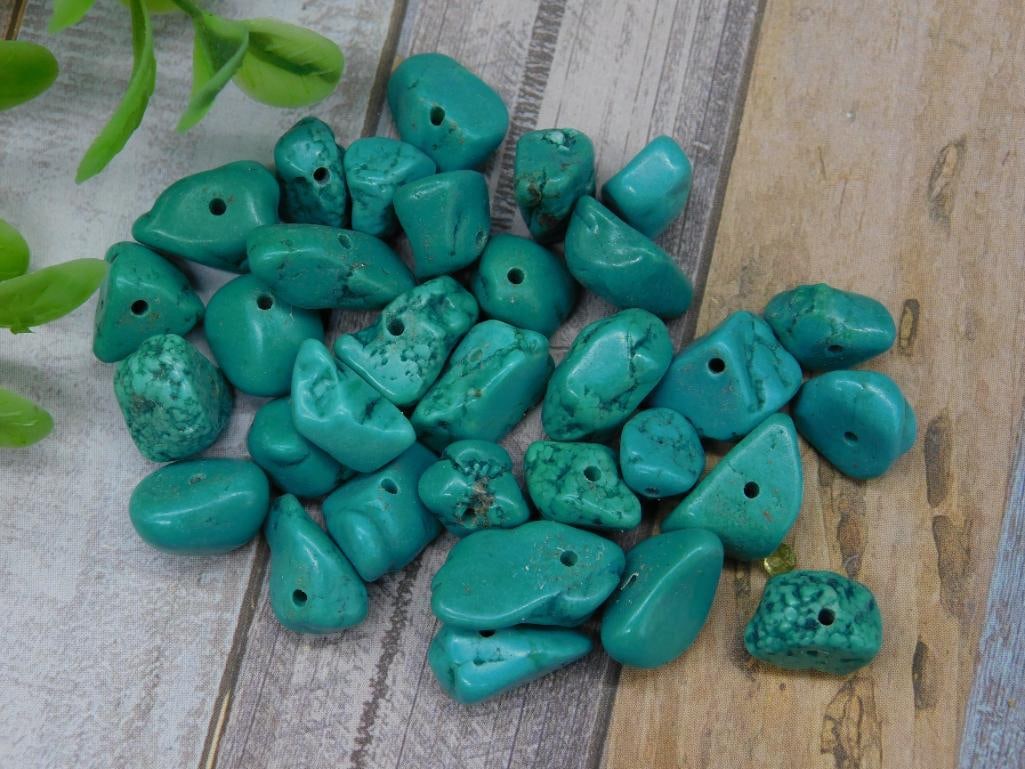 27 Grams of Drilled Turquoise Beads for Jewelry Making: Lot of drilled turquoise beads weighing 27 grams. The lot includes various sizes and shapes, ideal for jewelry making. Each bead features a pre-drilled hole for easy stringing. Quarter in the images f