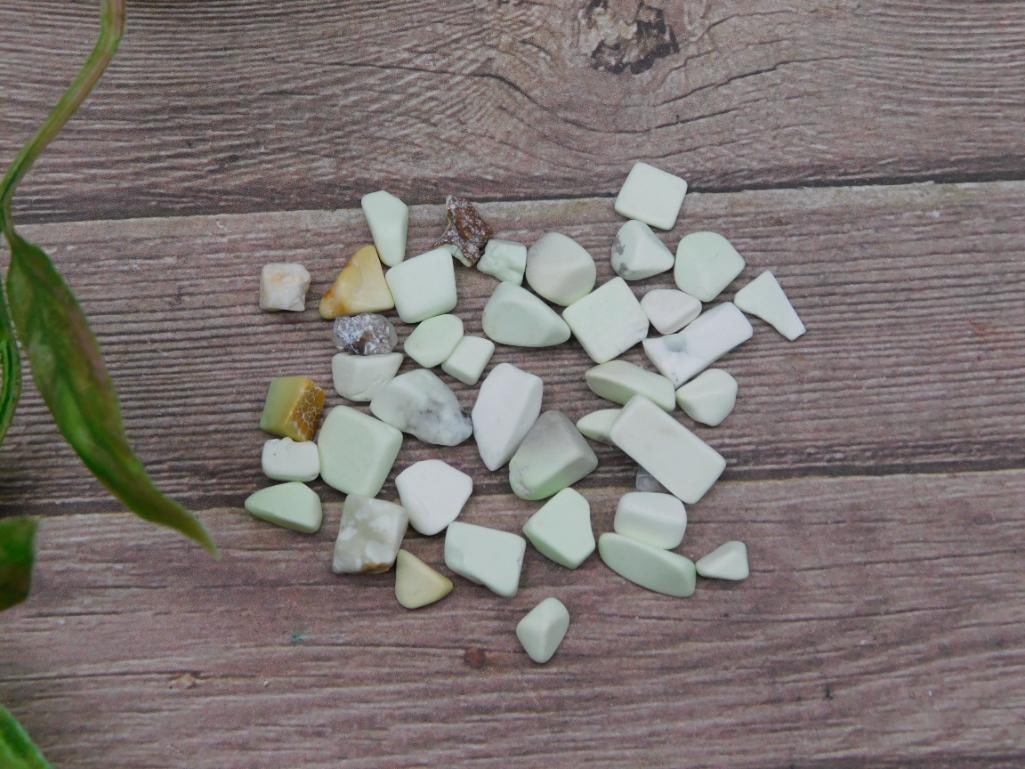12 Grams of Lemon Chrysoprase Gemstones: A set of Lemon Chrysoprase gemstone chips weighing 12 grams. Contains various small pieces with light green and white hues. Ideal for crafting or collection purposes. Includes an original labeled pack