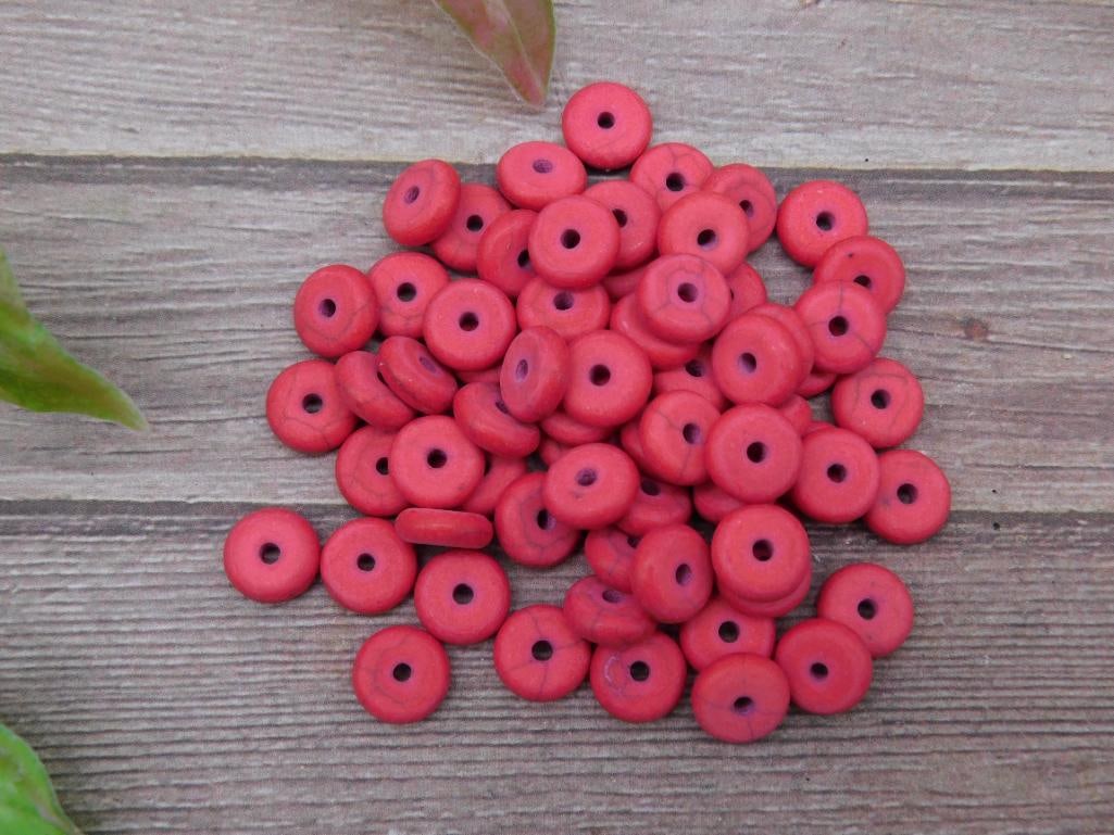 Lot of Small Red Disc Beads for Crafting and Jewelry: This lot contains a collection of small red disc-shaped beads with a single hole in the center, ideal for crafting or jewelry-making projects. The beads are uniformly sized, with a width that measures
