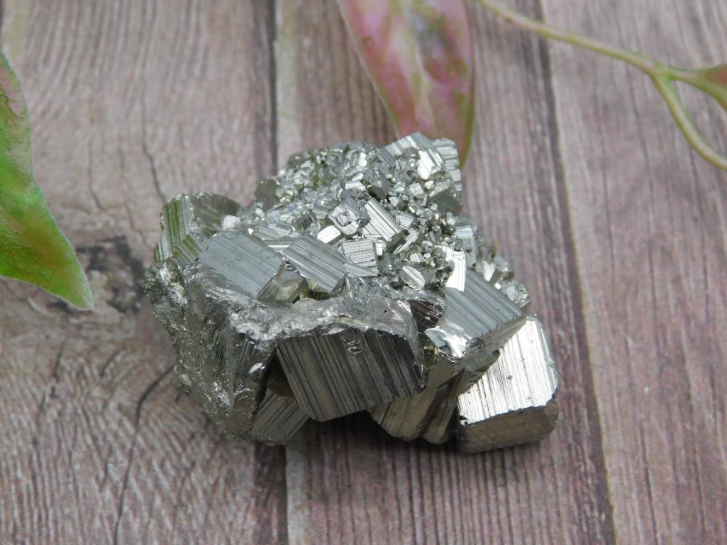 Pyrite Mineral Specimen with Cubic Crystals: A natural pyrite mineral specimen featuring well-defined cubic crystal formations. The metallic luster and structure are characteristic of pyrite. Ideal for collectors or as a display piece. The speci