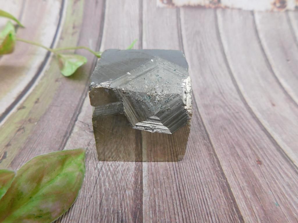 Pyrite Cube Mineral Rock Stone Lapidary Specimen: Natural pyrite cube specimen with a metallic luster and geometric form. The cube appears to be intact with naturally occurring imperfections on its surface. Ideal for use in mineral collections, displ