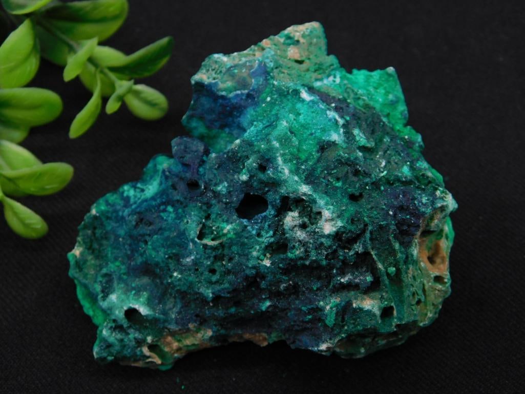 Large Malachite and Azurite Mineral Specimen: A beautiful mineral specimen showcasing vibrant shades of green and blue, characteristic of malachite and azurite. This piece features a rugged surface with natural holes and texturing. It weighs appr