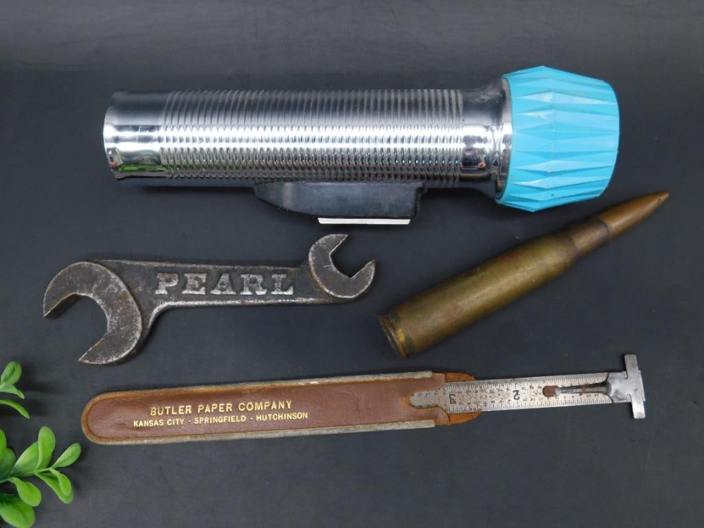 Assorted Vintage Tools and Ammunition Lot: This lot includes a selection of items: a metal flashlight with a blue endcap, an open-end wrench stamped with 'PEARL,' a marked tool by Butler Paper Company from Kansas City, Springfield, and Hutchin