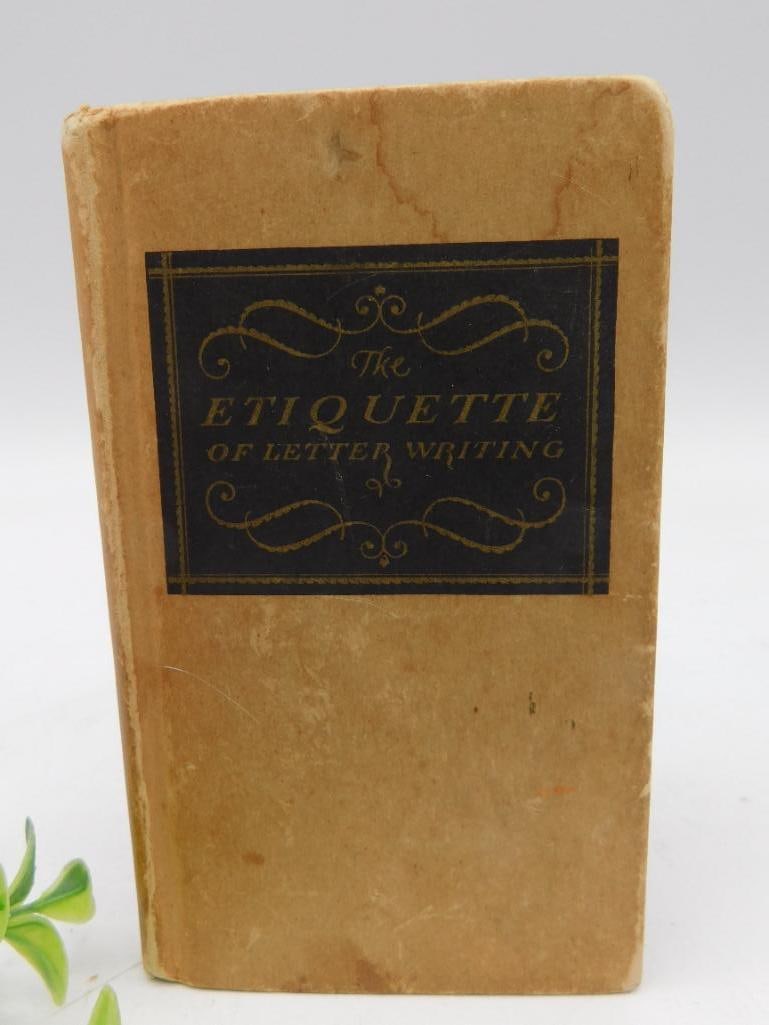 The Etiquette of Letter Writing Book, 1927: A desk book titled 'The Etiquette of Letter Writing: And Social Correspondence in General.' Published in 1927 by Chas. A. Fleet Company. Includes handwritten notes on several pages. The book features 