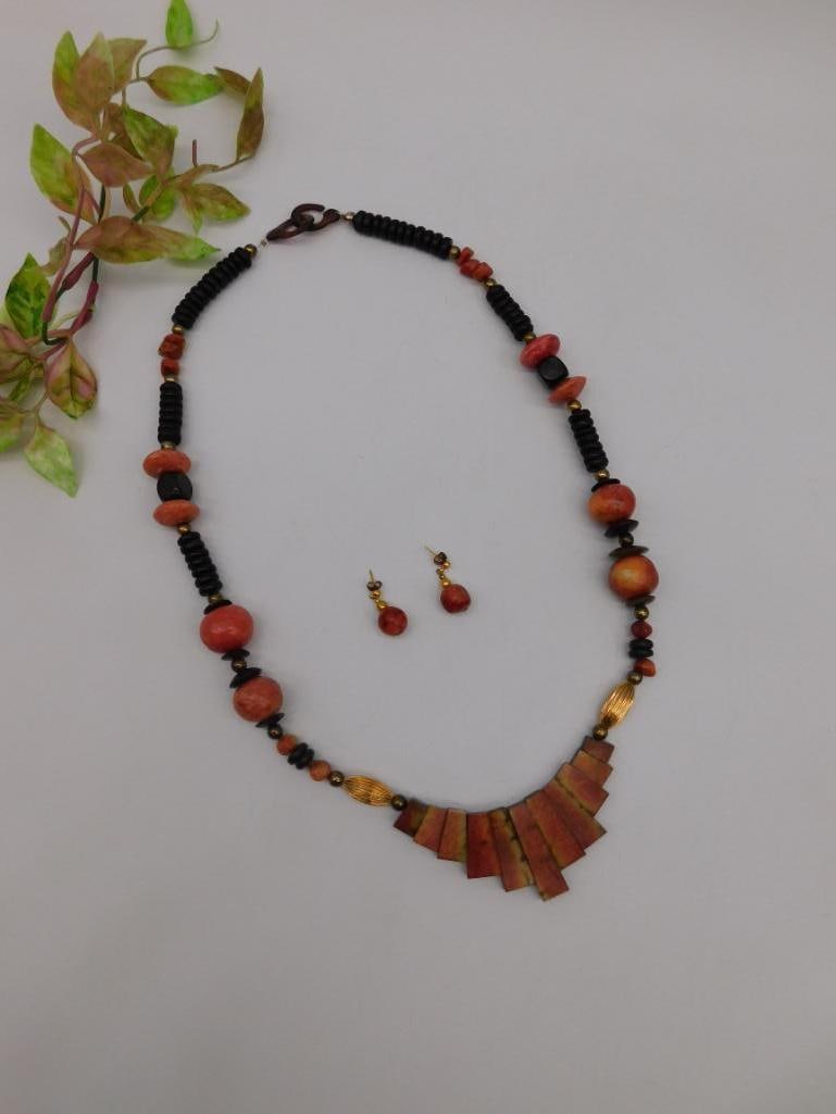 Beaded Statement Necklace and Earrings Set: Necklace and earring set featuring a vibrant beaded design. Necklace includes red and black beads arranged in an alternating pattern, enhanced with gold-tone accents and rectangular fan-shaped pendant