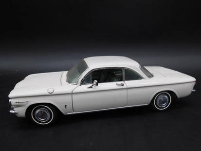 Franklin Mint 1960 Chevrolet Corvair Model Car: Franklin Mint Precision Model of a 1960 Chevrolet Corvair. Features intricate detailing with white exterior and realistic craftsmanship. Base includes identifying markers and branding. Comes with visi