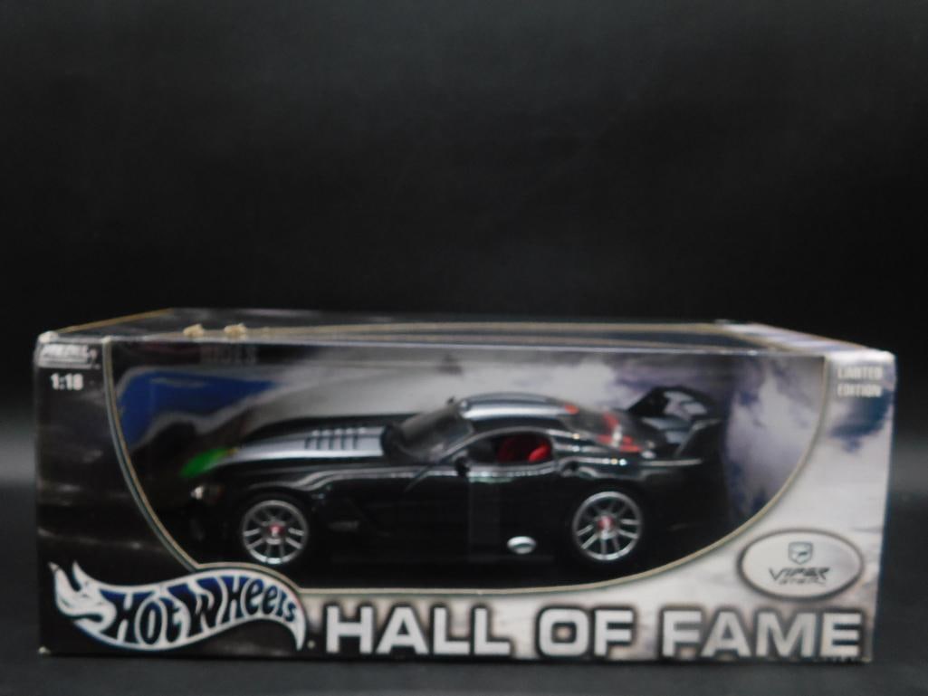 Hot Wheels Hall of Fame Dodge Viper GTS-R 1:18 Die-Cast Model: Hot Wheels Hall of Fame series collectible featuring the Dodge Viper GTS-R in 1:18 scale. The model comes in its original packaging, showcasing realistic detailing and styling. Packaging and model are