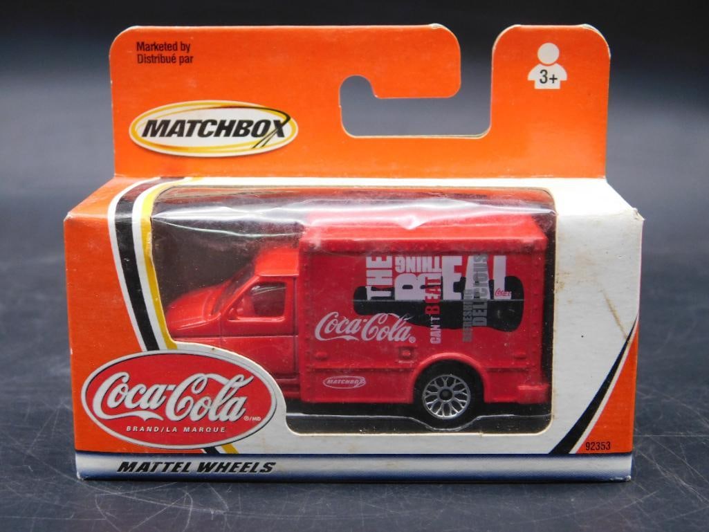 Matchbox Coca-Cola Brand Die-Cast Van in Original Packaging: This Matchbox Coca-Cola branded die-cast van comes in its original packaging. Manufactured by Mattel, the item is designed for children aged 3 and up. The packaging features the iconic Coca-Cola brand