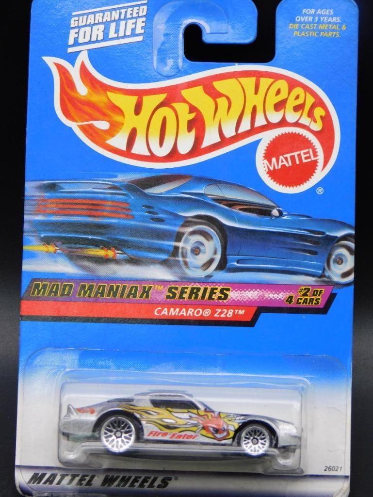 Mattel Hot Wheels Mad Maniax Camaro Z28: This Mattel Hot Wheels car is part of the Mad Maniax series, featuring the Camaro Z28 model. It is packaged on its original card in unopened condition and is labeled as No. 2 of 4 cars in the series.