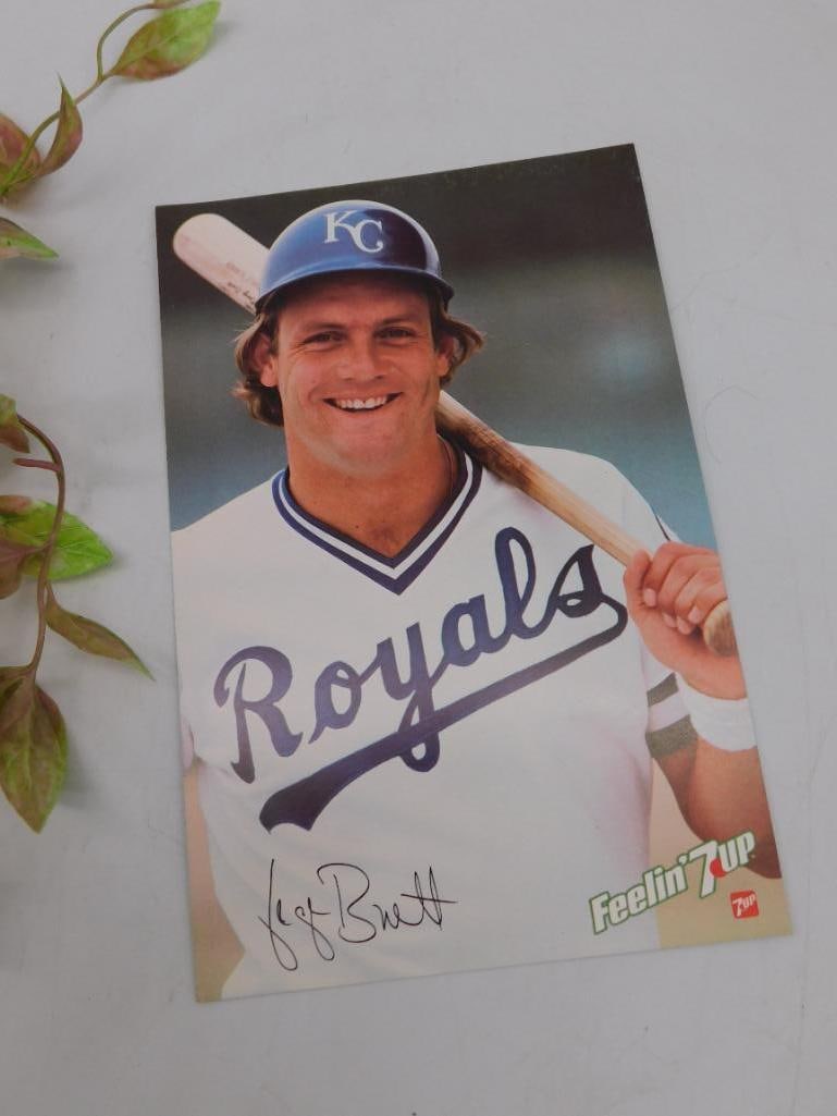 George Brett Kansas City Royals Feelin' 7UP Promo Card: George Brett promotional card featuring the Kansas City Royals baseball player in a 'Feelin' 7UP' collaboration. The front side showcases Brett with a baseball bat and his signature in print. The back