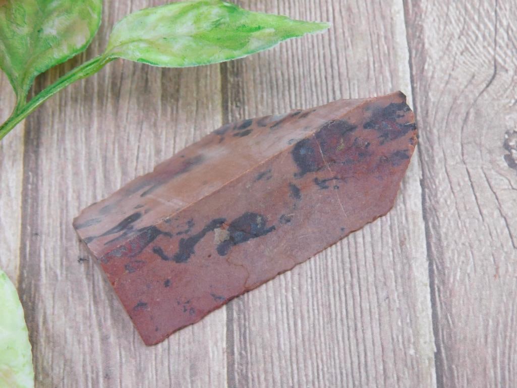 Natural OBSIDIAN Stone Slice, 19 Grams: This is a natural jasper stone slice, weighing 19 grams. The stone features a mix of reddish and black colors with a unique pattern. It may have been cut or shaped from a larger piece of jasper. The e