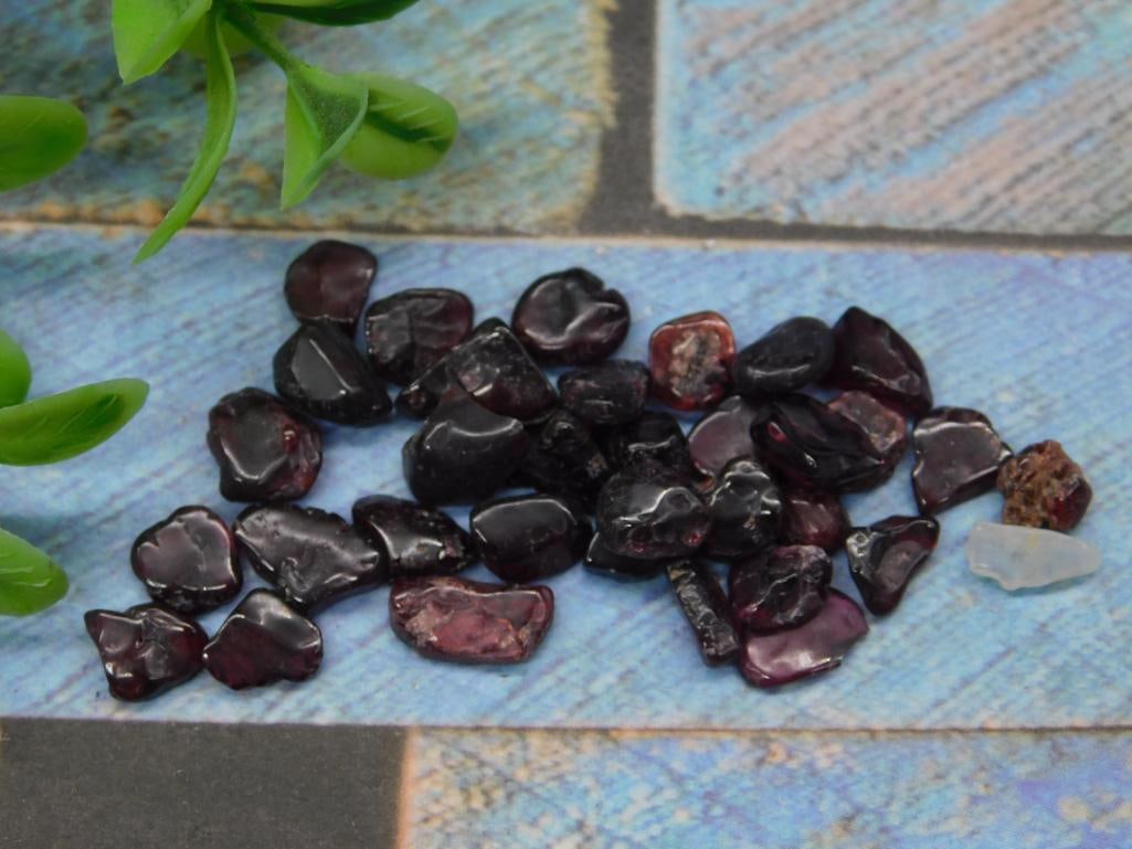 Lot of Polished GARNET Gemstones for Collectors: A collection of polished dark red gemstones, with a variety of smooth and irregular shapes. The gemstones exhibit a glossy finish and dark red hues. Includes an assortment of shapes and sizes, as show