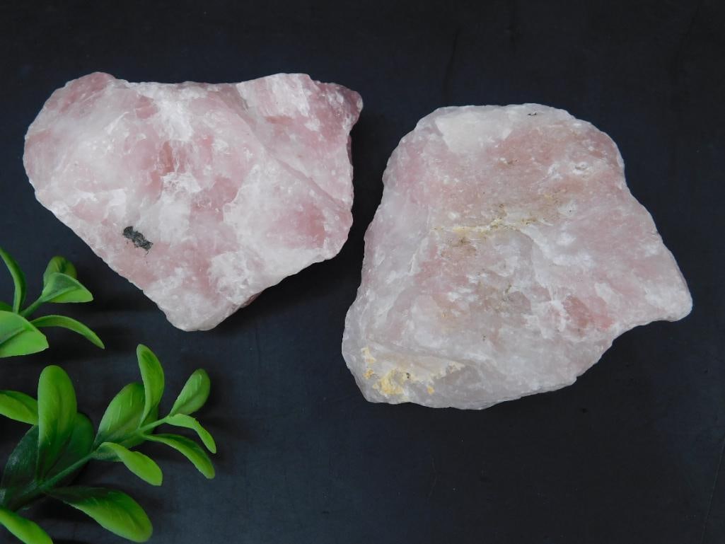 Pair of Raw Pink Quartz Mineral Specimens: This is a lot of two raw pink quartz mineral specimens. Each specimen features natural pink and white tones with visible textures and raw edges. Ideal for collectors or mineral enthusiasts. Measuremen