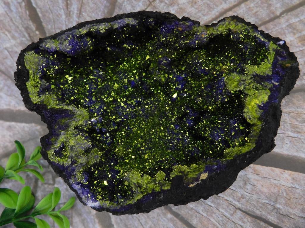 Vibrant Geode Specimen with Green and Blue Crystals: This striking mineral specimen features vibrant green and deep blue crystalline structures on a textured black base. The specimen demonstrates a unique visual contrast between its bold colors and natu