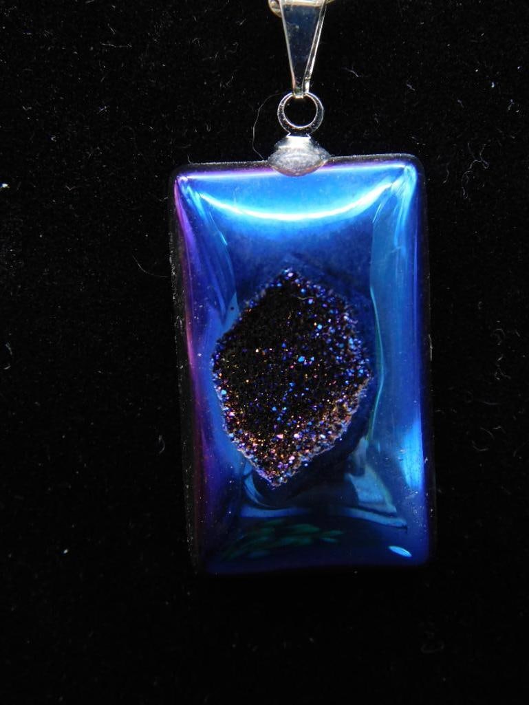 Blue DRUZY TITANIUM Pendant Necklace with Chain: This lot features a stunning blue DRUZY TITANIUM pendant attached to a metal bail, suspended on a silver-tone chain. The dichroic glass showcases a shimmering, textured surface in the center, creating
