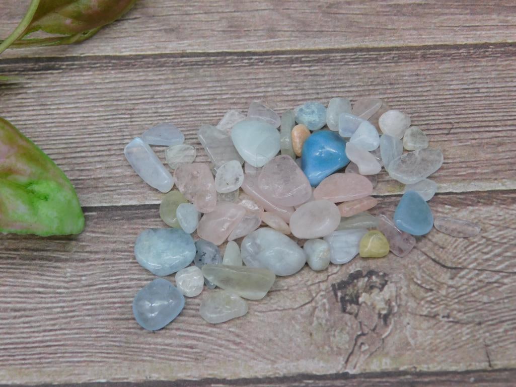 Assorted Polished Gemstones, 12 Grams: This lot contains assorted polished gemstone chips totaling 12 grams. The stones come in various colors and shapes, including clear, blue, pink, and yellow tones. Ideal for crafting, collection, or ot