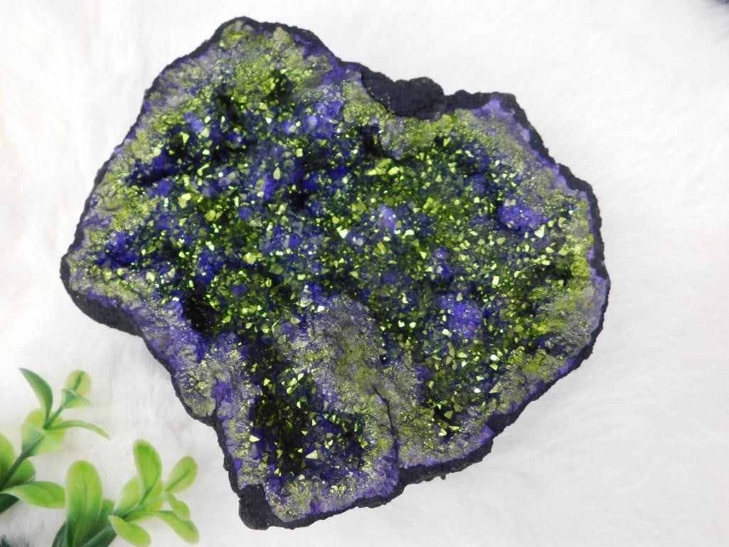 Purple and Green Druzy Mineral Specimen with Sparkling Crystals: This is a druzy mineral specimen featuring vibrant purple and green crystal formations. The surface is heavily encrusted with sparkling druzy crystals, creating a striking contrast between its colors.
