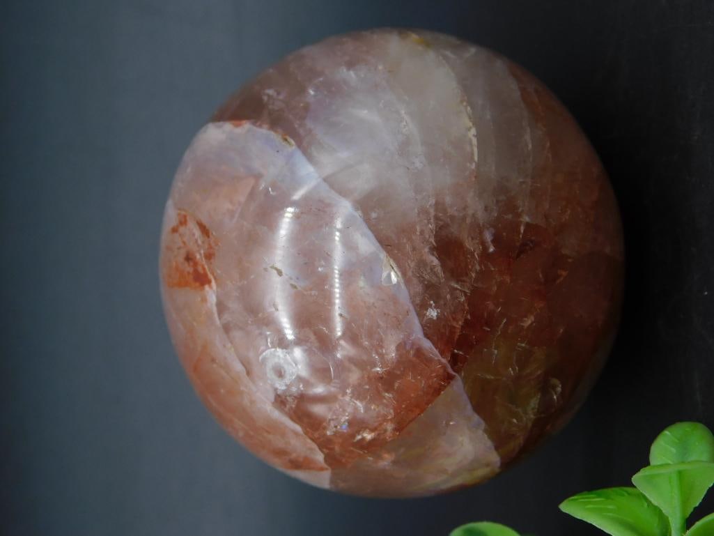 Polished Banded Stone Sphere With Stand: A polished spherical stone featuring natural banded tones and a smooth finish. Weighs 251 grams as documented. Includes measuring scale for approximate sizing reference. Ideal for display purposes or 