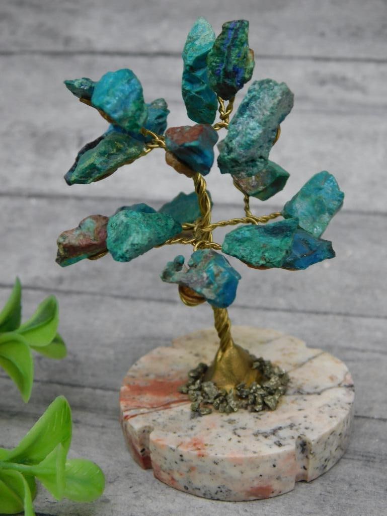 Wire and Stone Gem Tree With Stone Base: Wire-wrapped decorative tree adorned with green and blue stone crystal formations. Features a polished stone base with natural patterns and tones. Compact size ideal for display on desks, shelves, or 