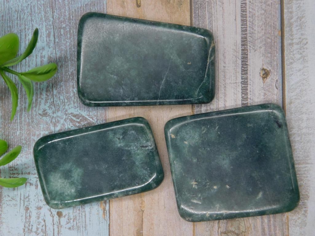 Nephrite Jade Rock Stone Lapidary Specimen: Set of three dark green stone slabs with polished surfaces. Each piece shows natural variations and inclusions inherent to the stone. Dimensions vary slightly across the three slabs. Total weight of t