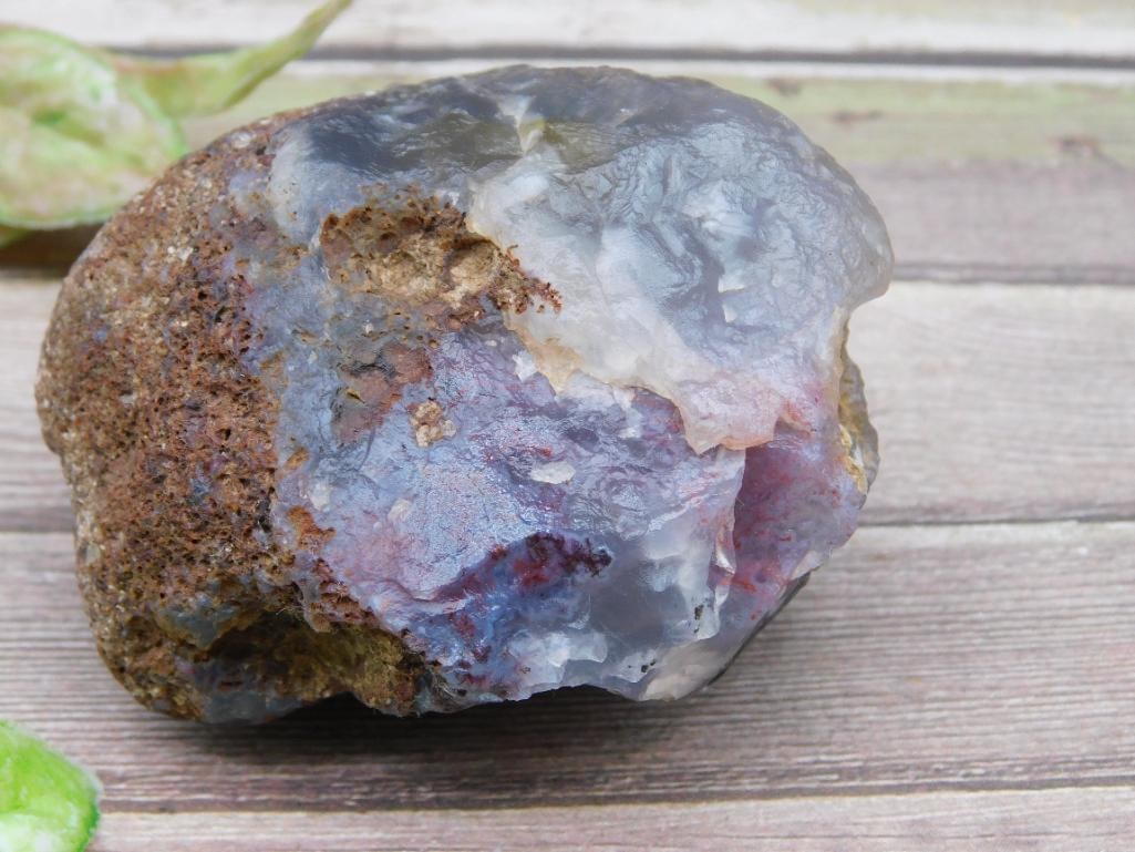 Rough Rock Specimen With Multicolored Features: This is a rough rock specimen displaying a natural matrix with multicolored features including shades of gray, blue, red, and hints of yellow. The total weight of the specimen is labeled as 181 grams.