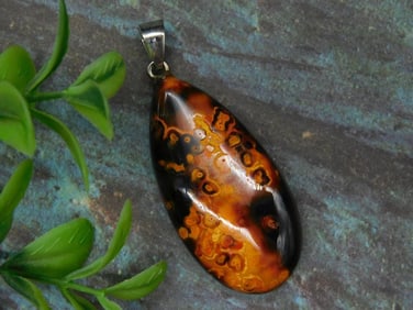 Polished Pendant With Intricate Patterns