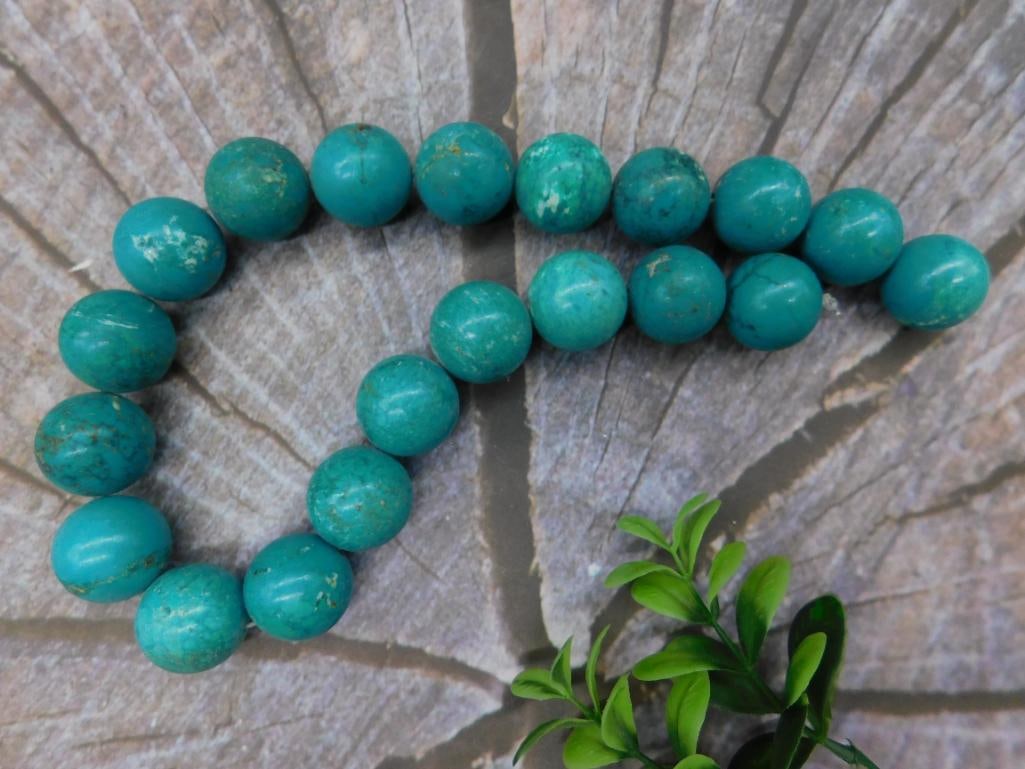 Strand of Round Turquoise Beads ? 232 Grams Rock Stone Lapidary Specimen: Strand of round turquoise beads weighing 232 grams. Each bead appears to be consistently round, with a uniform turquoise coloring and accents of natural patterns. Ideal for crafting or collecting. Mea