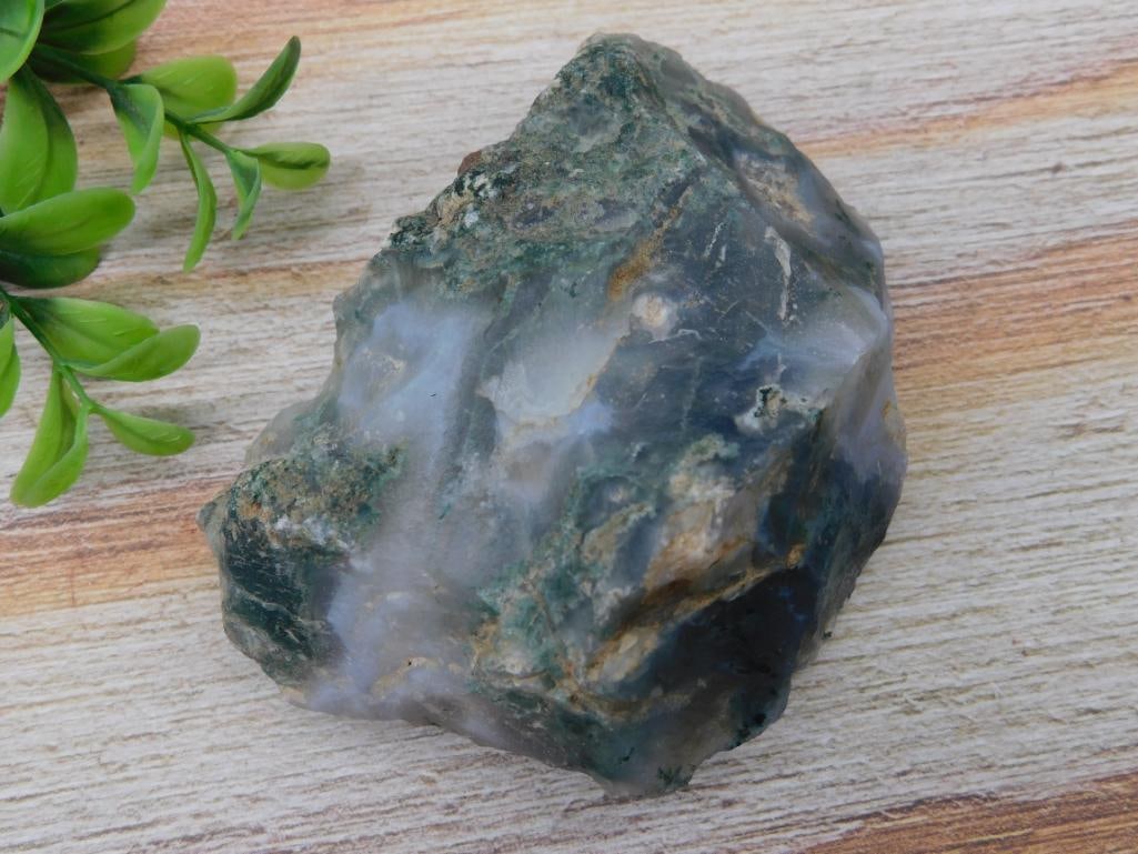 MOSS PLUME AGATE Rock Stone Lapidary Specimen: This listing features a rough specimen of green and white mineral rock. The rock has a natural, unpolished form with visible multi-tonal green areas and white inclusions. The approximate size and mass