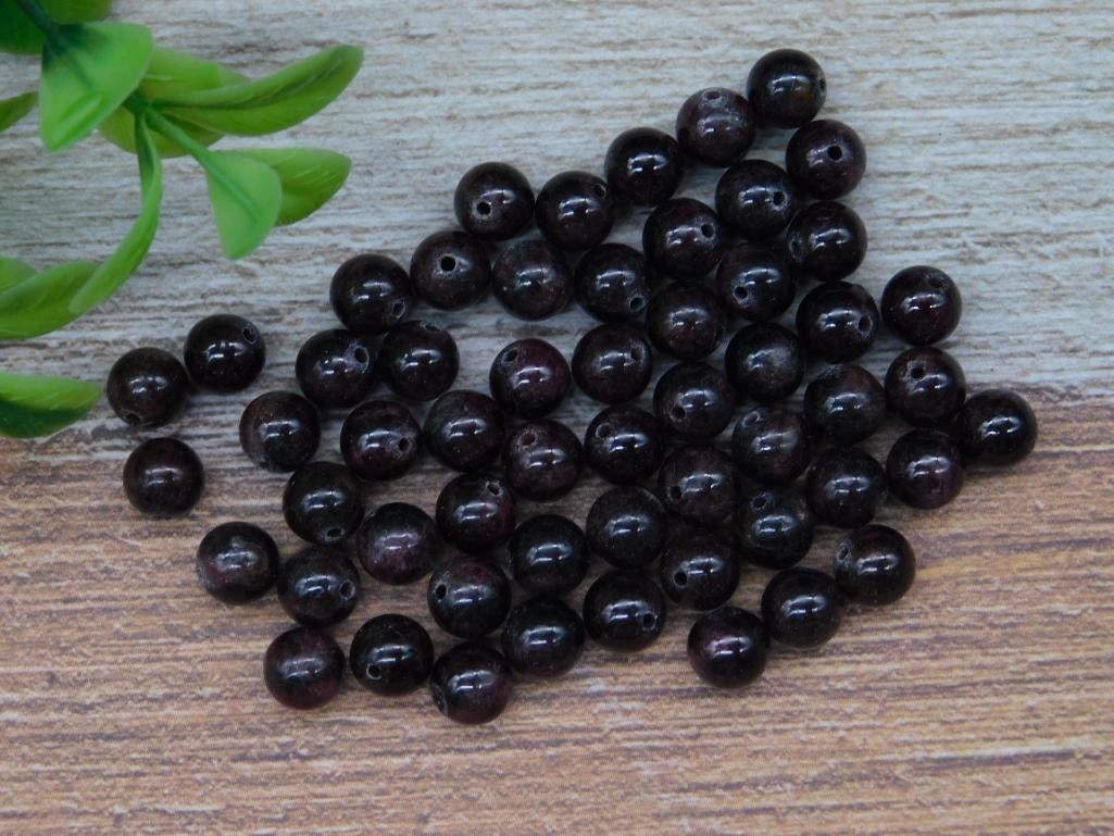 Lot of Round Dark Red Garnet Drilled Gemstone Beads, 41 Grams: This lot includes a collection of 41 grams of round dark red gemstone beads. Each bead is pre-drilled, making them suitable for jewelry-making or craft projects. The beads are uniform in shape and siz