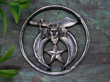 Metallic Medallion with Sword and Star Design