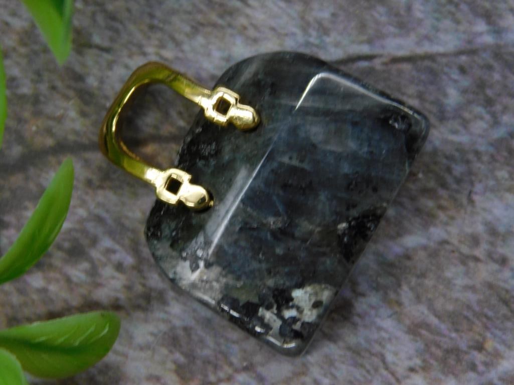 Labradorite Purse Rock Stone Lapidary Specimen: Rectangular stone pendant featuring natural dark tones with a gold-tone bail for attachment. The stone displays unique patterns and textures. Approximate weight is 11 grams. Suitable for jewelry-makin