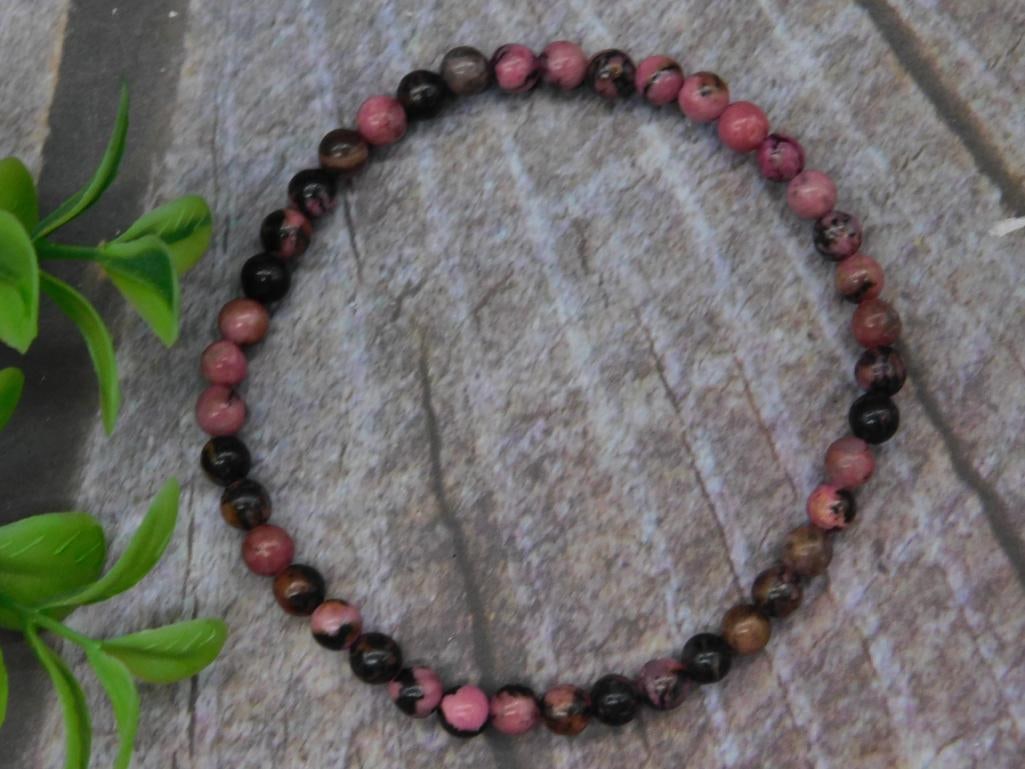 Rhodonite Stretch Bracelet ROCK STONE LAPIDARY SPECIMEN: A stretch bracelet made with alternating pink and black round beads. The beads are uniform in size, and the elastic band allows for a comfortable fit. This piece is ideal for everyday wear or simple a