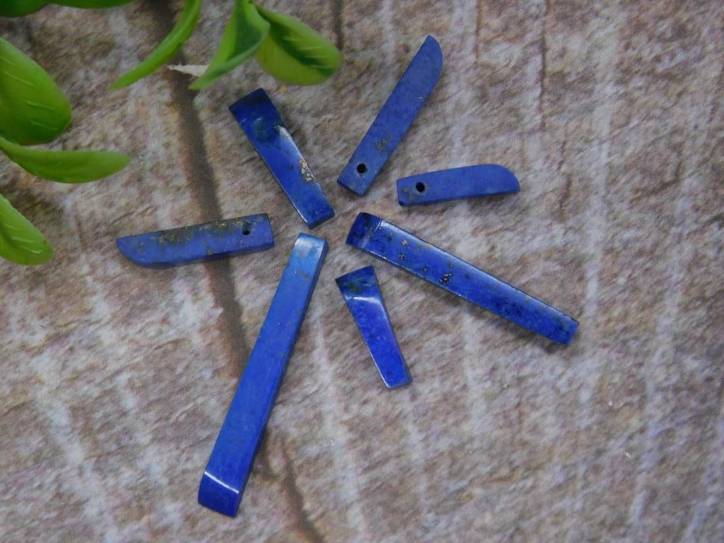 Assorted Lapis Lazuli Stone Shards for Jewelry Making: A collection of assorted lapis lazuli shards, ideal for jewelry making or other craft projects. Includes 7 pieces of varying sizes and shapes, each featuring the characteristic deep blue hues of lapis