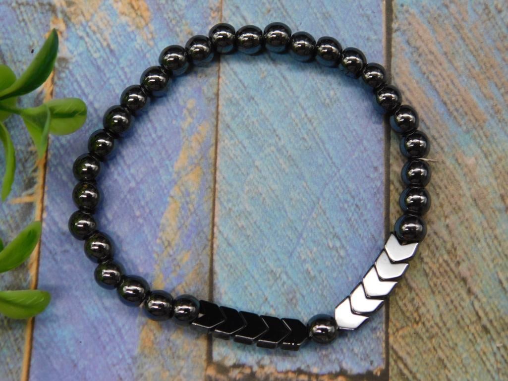 Black Beaded Stretch Bracelet With Chevron Accent: - Black stretch bracelet featuring round beads and chevron accent pieces. | - Elastic design for easy wear and comfortable fit. | - Beads have a shiny black finish, with chevron accents for added deta