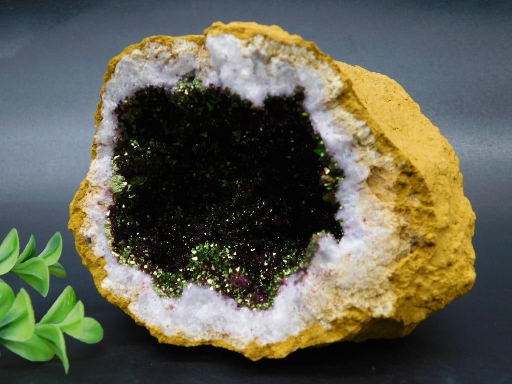 Natural Quartz Geode Crystal Specimen: This is a naturally occurring geode specimen featuring a vibrant green quartz crystal core surrounded by white quartz formations. The exterior displays its organic, rough-textured stone shell. The int