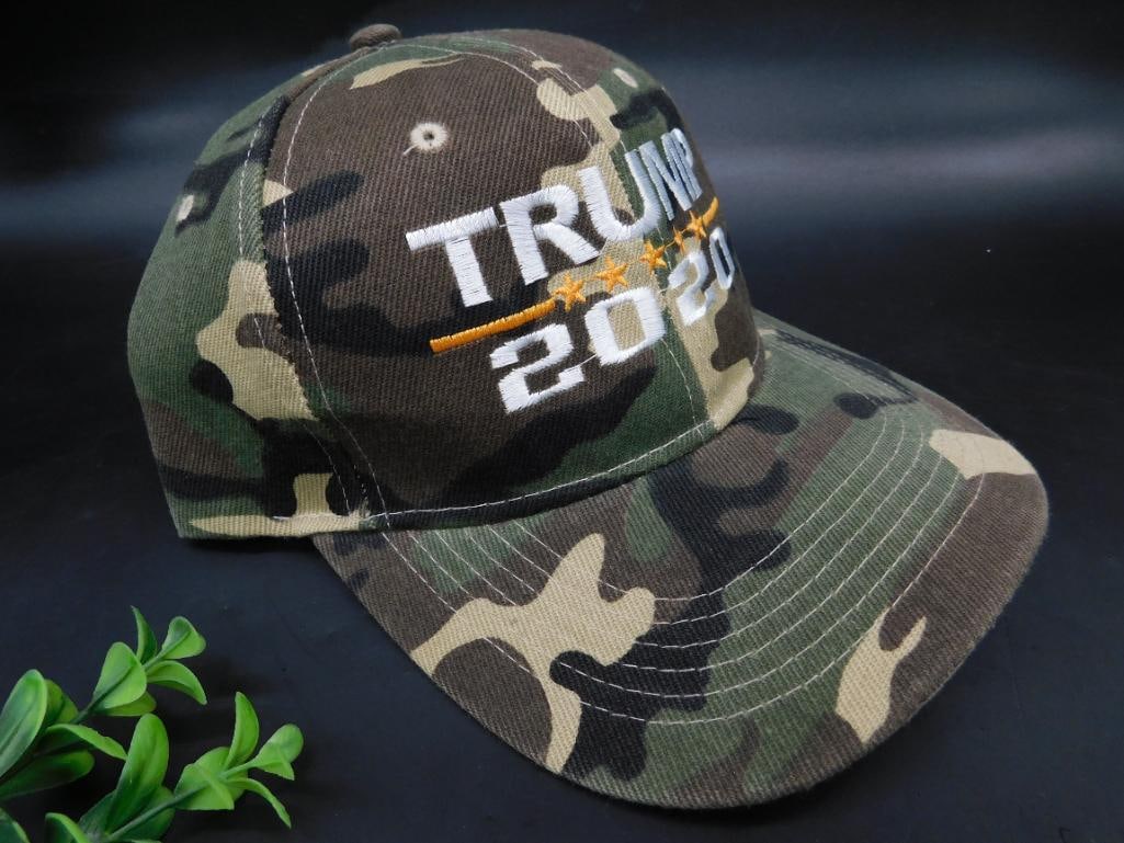 Trump 2020 Camouflage Baseball Cap with Embroidered Text and Stars Design: This item is a camouflage-patterned baseball cap featuring an embroidered "Trump 2020" text design with a star motif. Made from durable fabric, it has an adjustable strap at the back for a customizabl