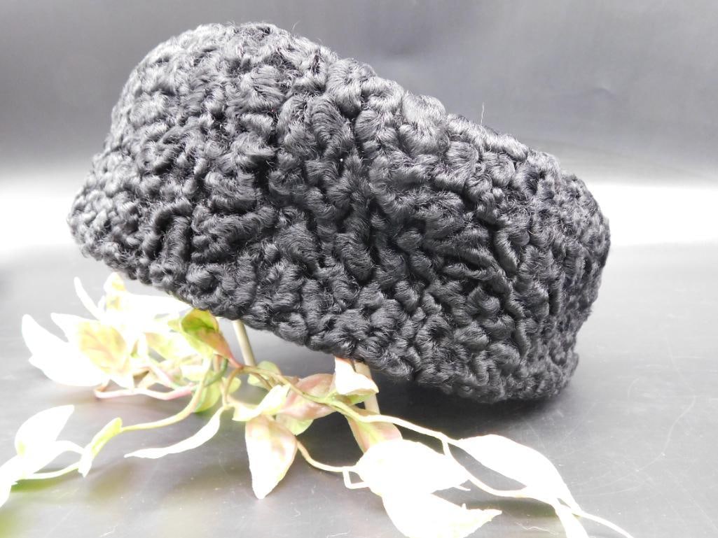 Black Knit-Style Winter Hat: Black knit-style hat with a textured design, ideal for winter wear. Shown in preserved condition with approximate size noted via ruler.
