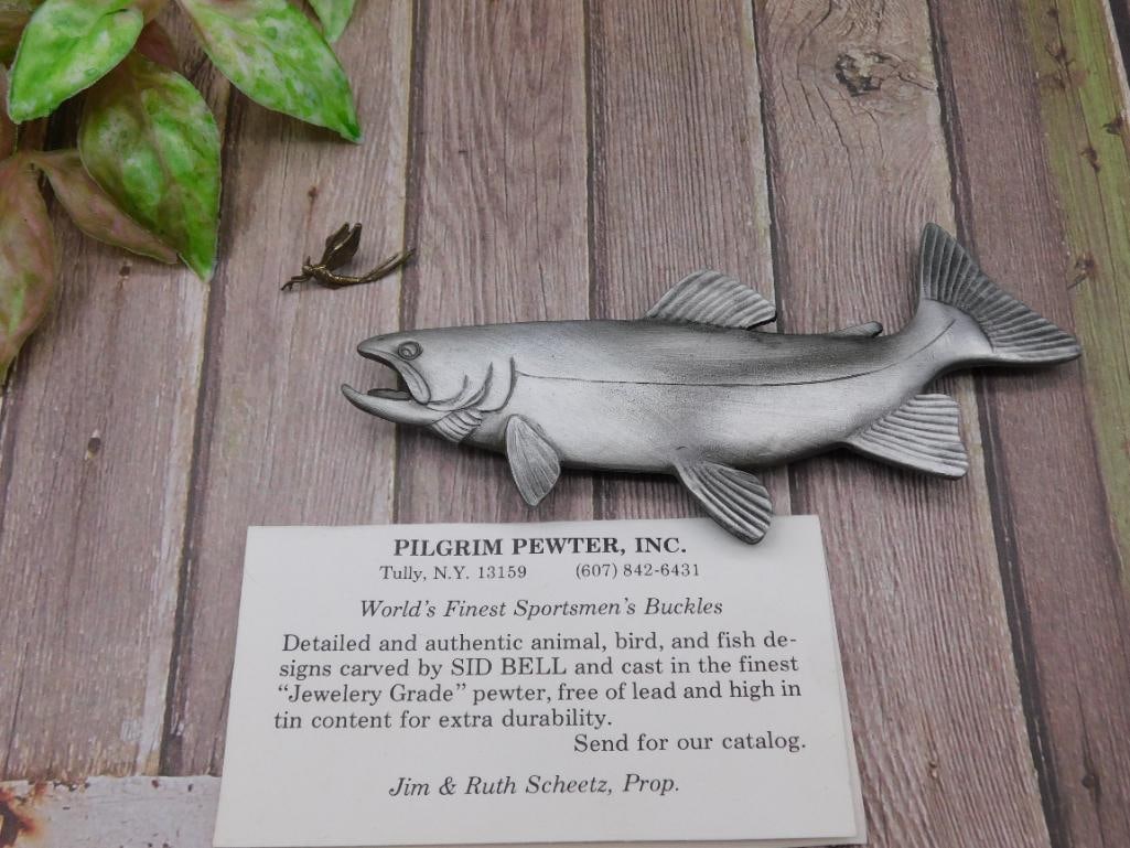 Pilgrim Pewter Trout and Fly Fishing Motif Piece: This item is a detailed pewter figure of a trout with a separate fly, crafted by Pilgrim Pewter, Inc. Made with high-quality 'Jewelry Grade' material, it is designed to be lead-free and high in tin co
