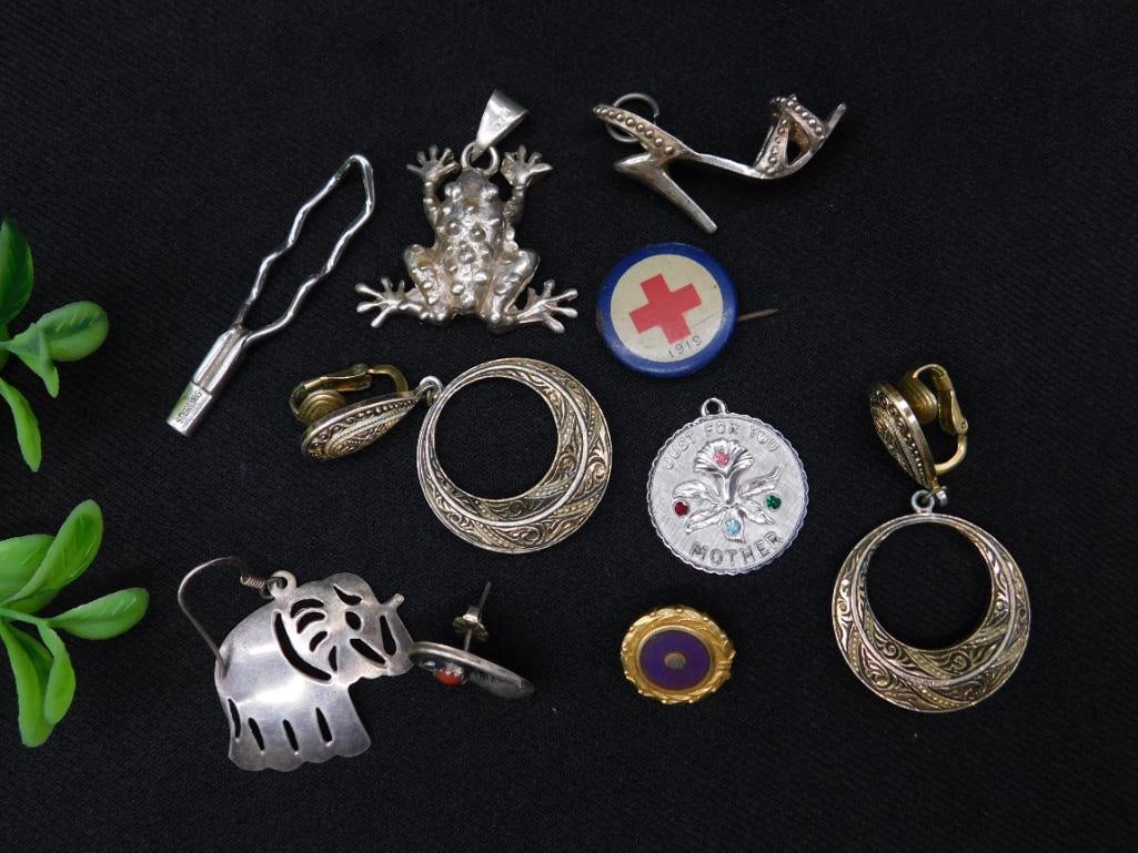 Collection of Mixed Jewelry and Charms, Sterling Marks: A varied collection of jewelry and charms, including a pair of hoop earrings with intricate designs, a frog pendant marked "TAXCO MEXICO," a stiletto shoe charm, a "Mother" pendant with enamel floral 