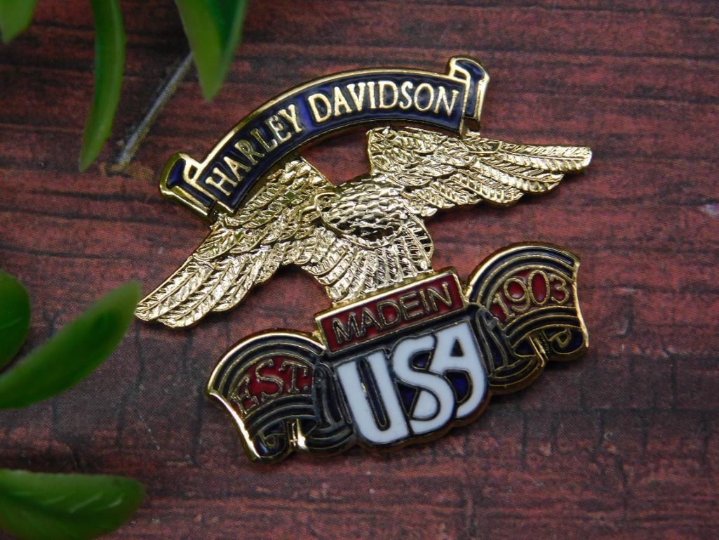 Harley Davidson Made in USA Metal Pin: Harley Davidson decorative metal pin featuring an eagle design with 'Made in USA' text and a banner marked '1903.' Includes a mix of gold-tone and enamel accenting. Compact size, perfect for display o