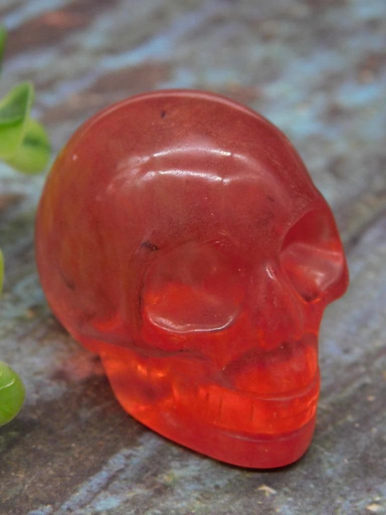 Red Stone Skull Sculpture Weighing 38 Grams ROCK STONE LAPIDARY SPECIMEN: This item is a skull sculpture crafted from red stone, weighing 38 grams. Its compact size is demonstrated next to a U.S. quarter in the image provided. Ideal for collectors, this piece is robust and 